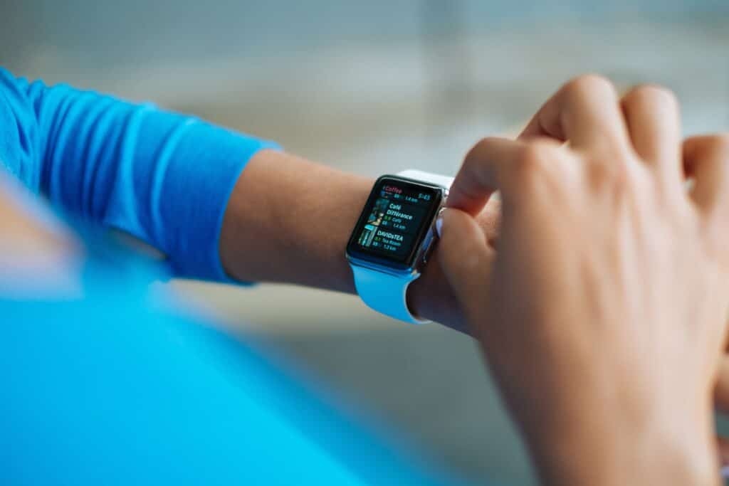 One of the best smartwatches being operated by a person in blue clothing